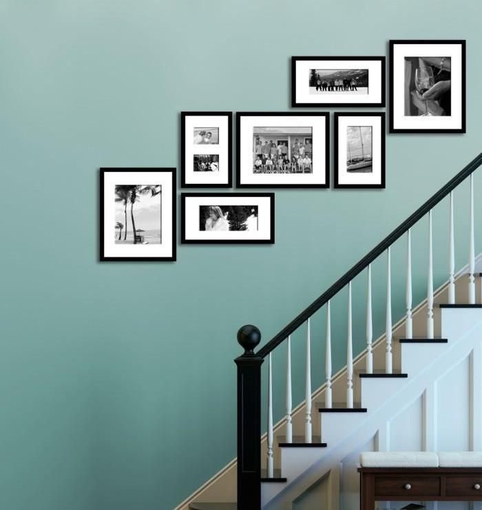 Family Photos Display Along The Staircase On The Blue Wall