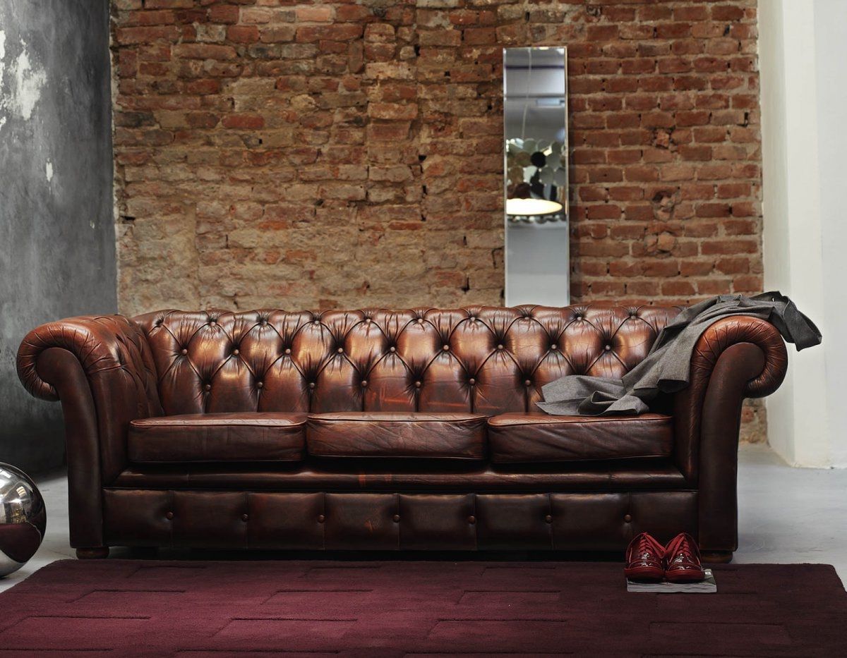 Old Exposed Brick Wall Accent Background With Rectangular Wall Mirror Set Behind Brown Leather Chesterfield Sofa Design (Photo 2482 of 7825)